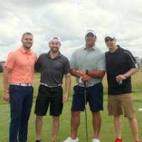 4 men ready to play on course